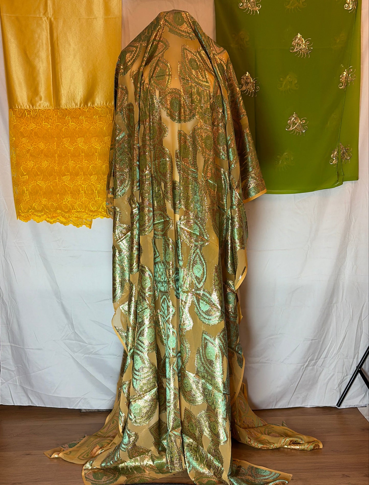 Gold fabric with intricate patterns on a white surface