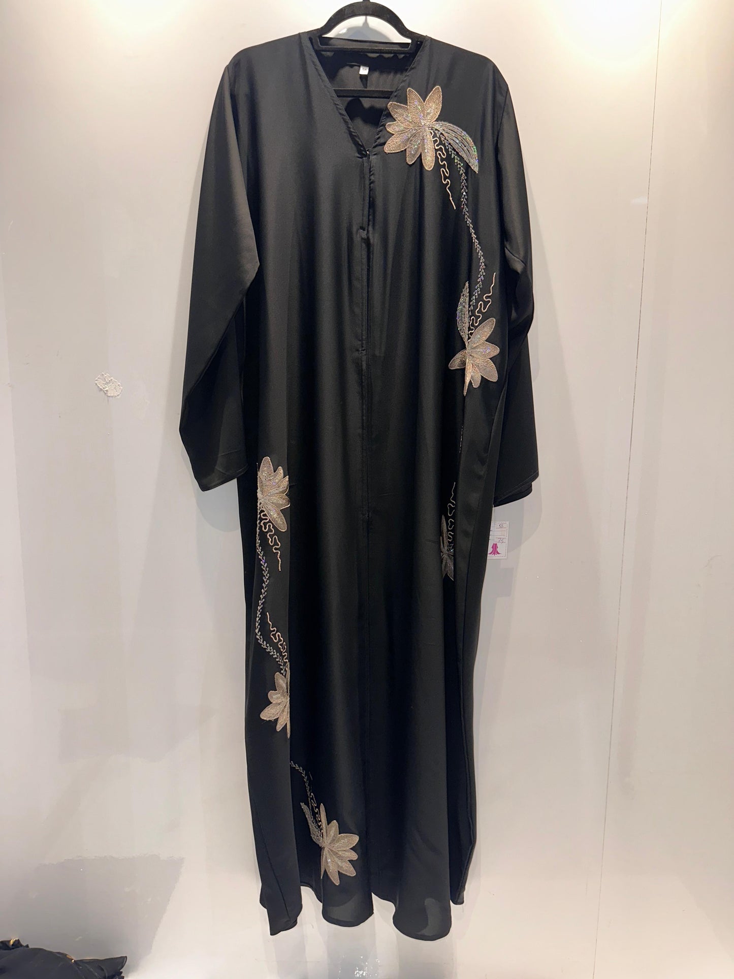 Black dress with floral embroidery on a white background