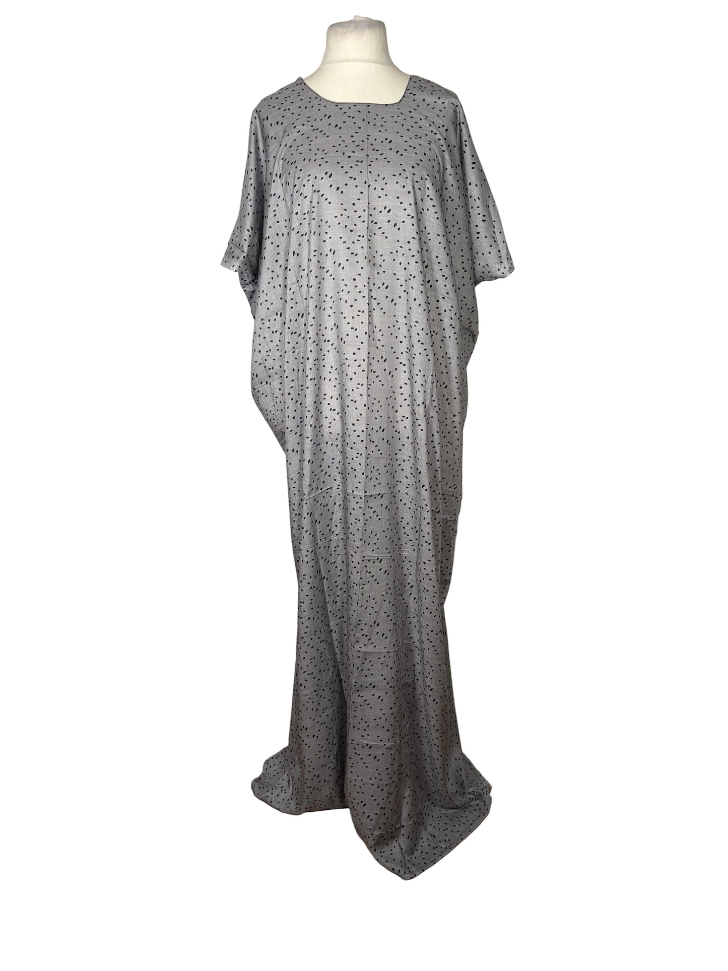 Gray dress with white polka dots on a mannequin against a white backdrop