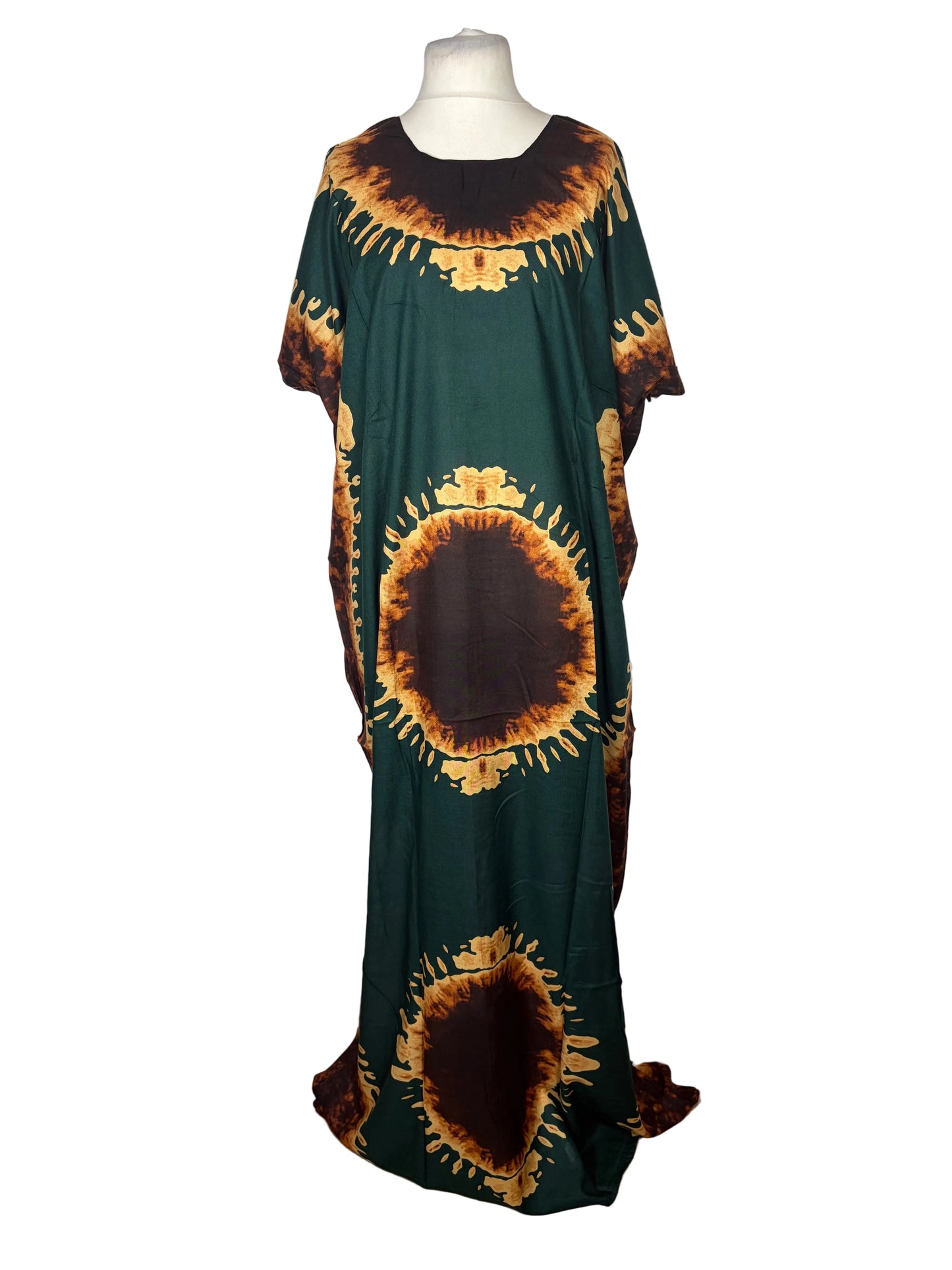 Green dress with sunflower pattern on a white surface