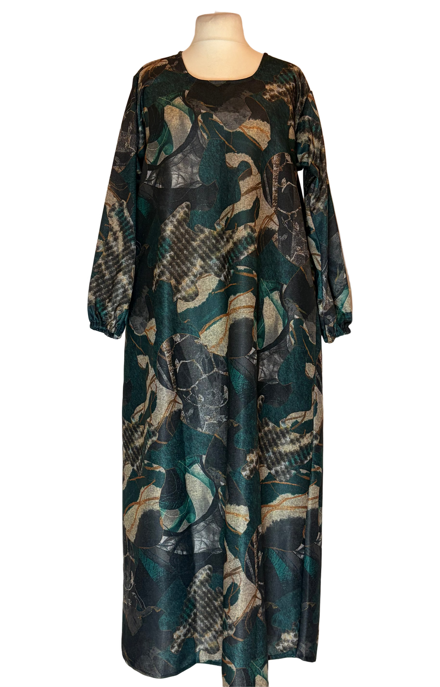 Long, patterned dress on a mannequin against a white background