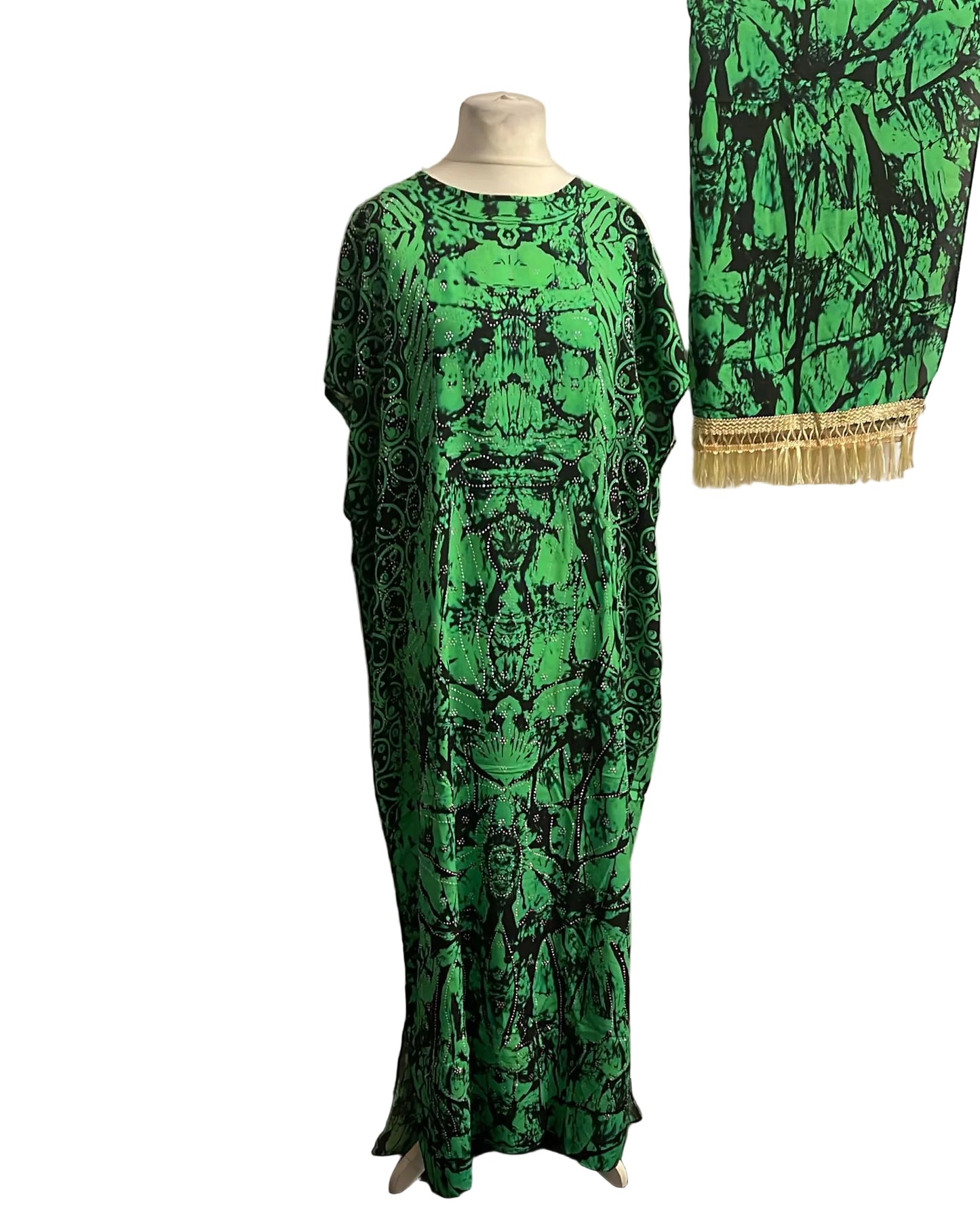 Green and black patterned Somali Baati on a mannequin against a white background