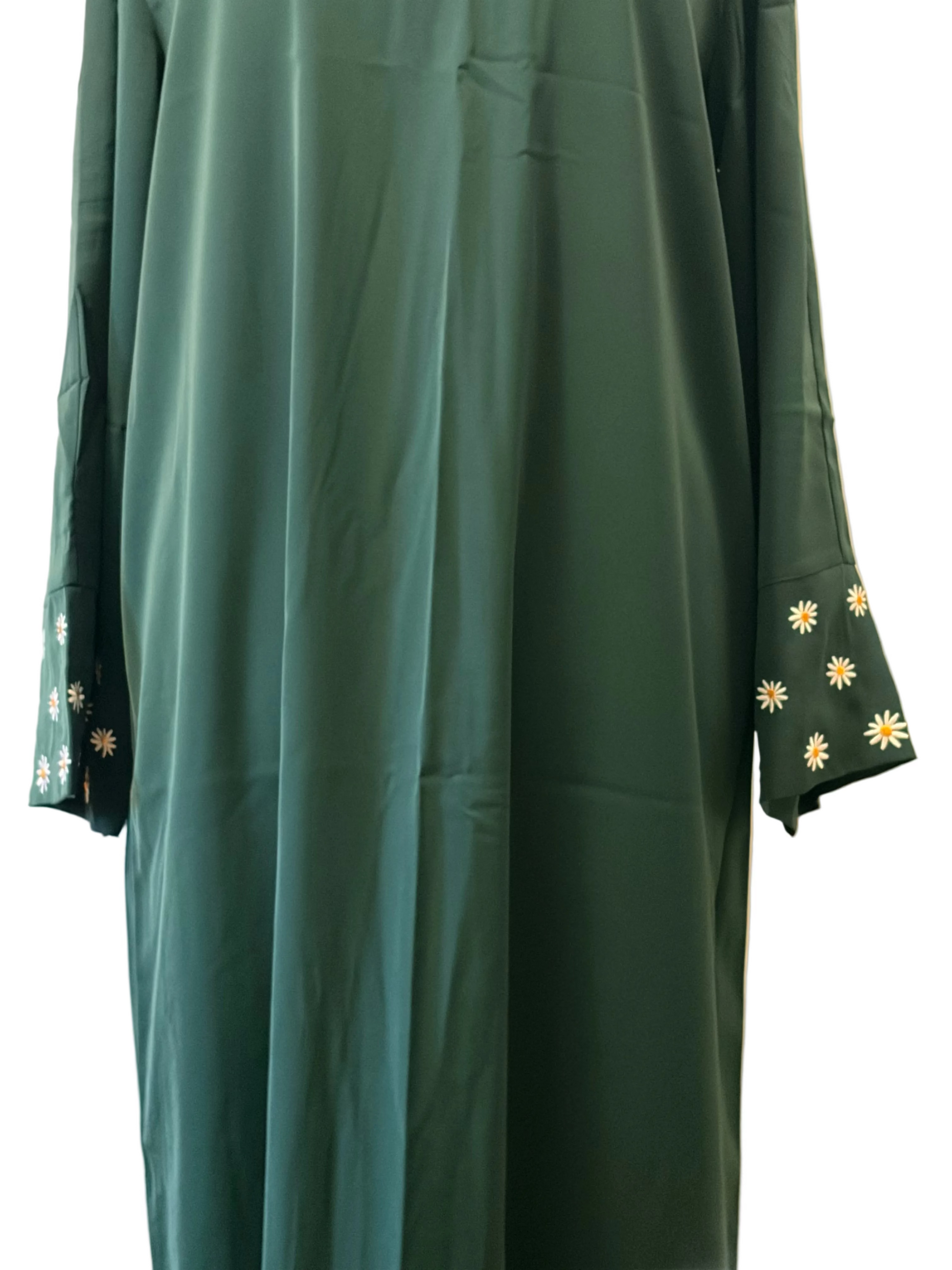 Green dress with floral embroidery on sleeves against a neutral background