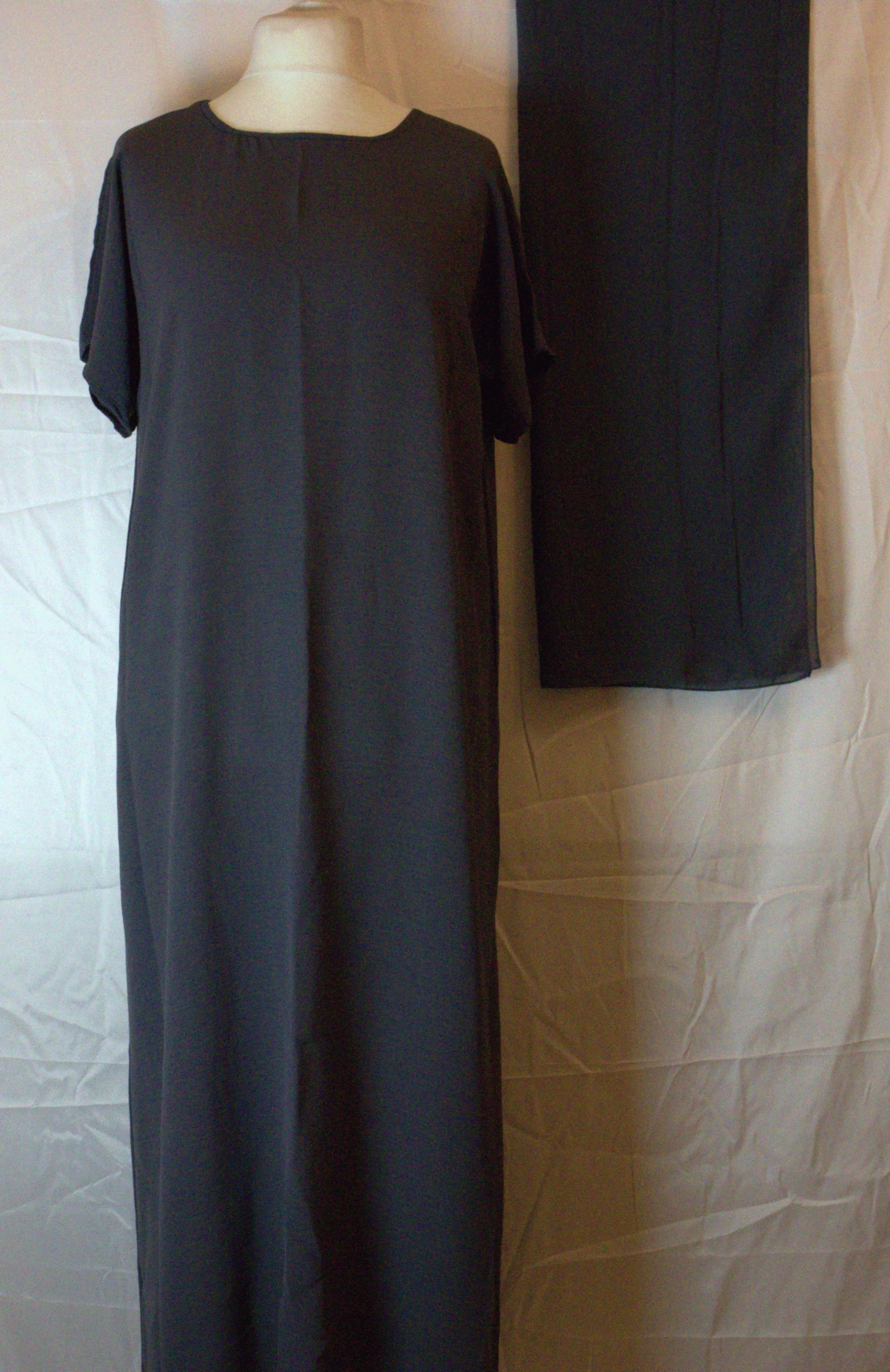 Long dark gray Abaya inside piece on a mannequin against a neutral background
