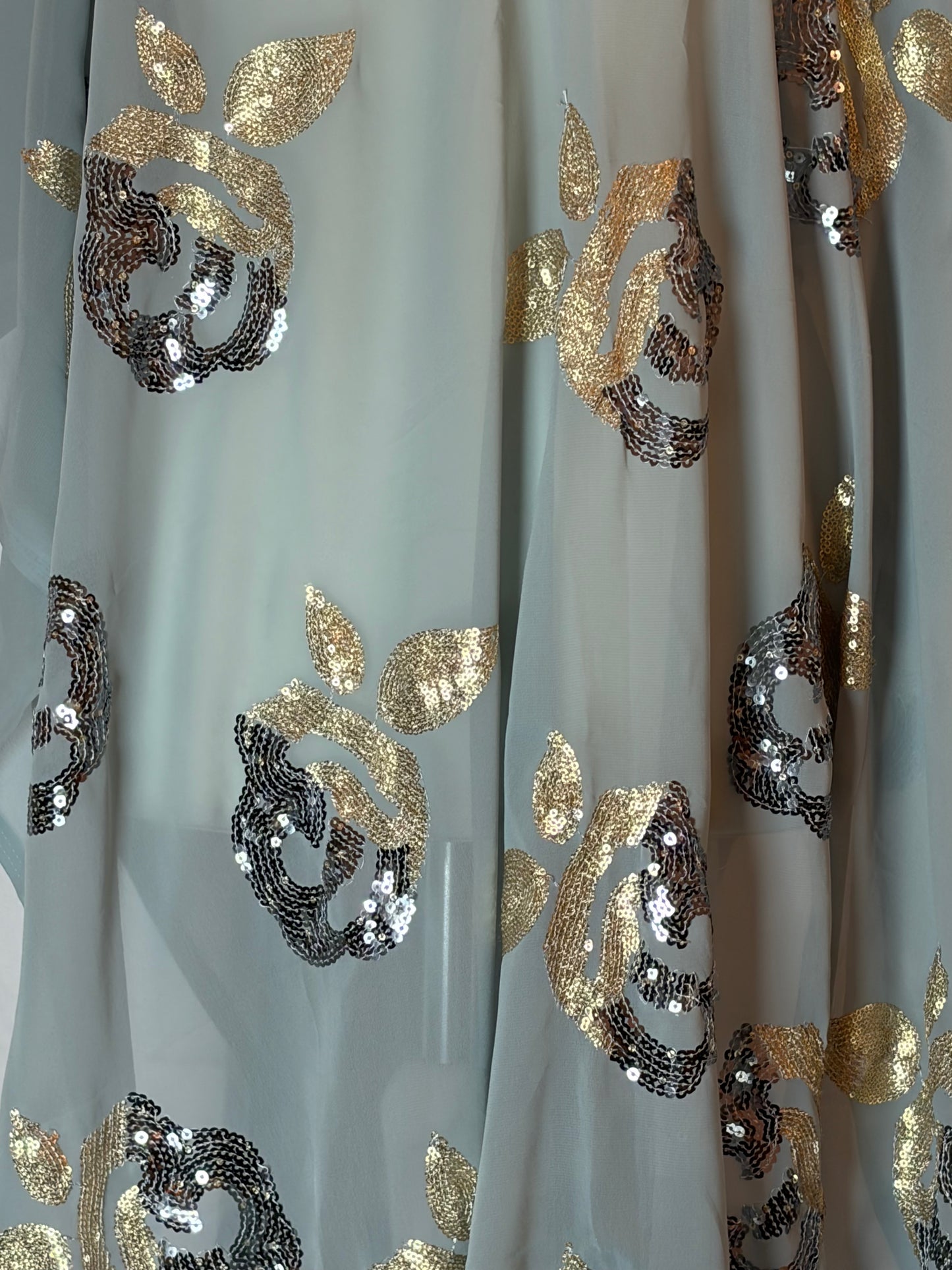 somali Garbasaar fabric with gold and silver floral patterns on a white background