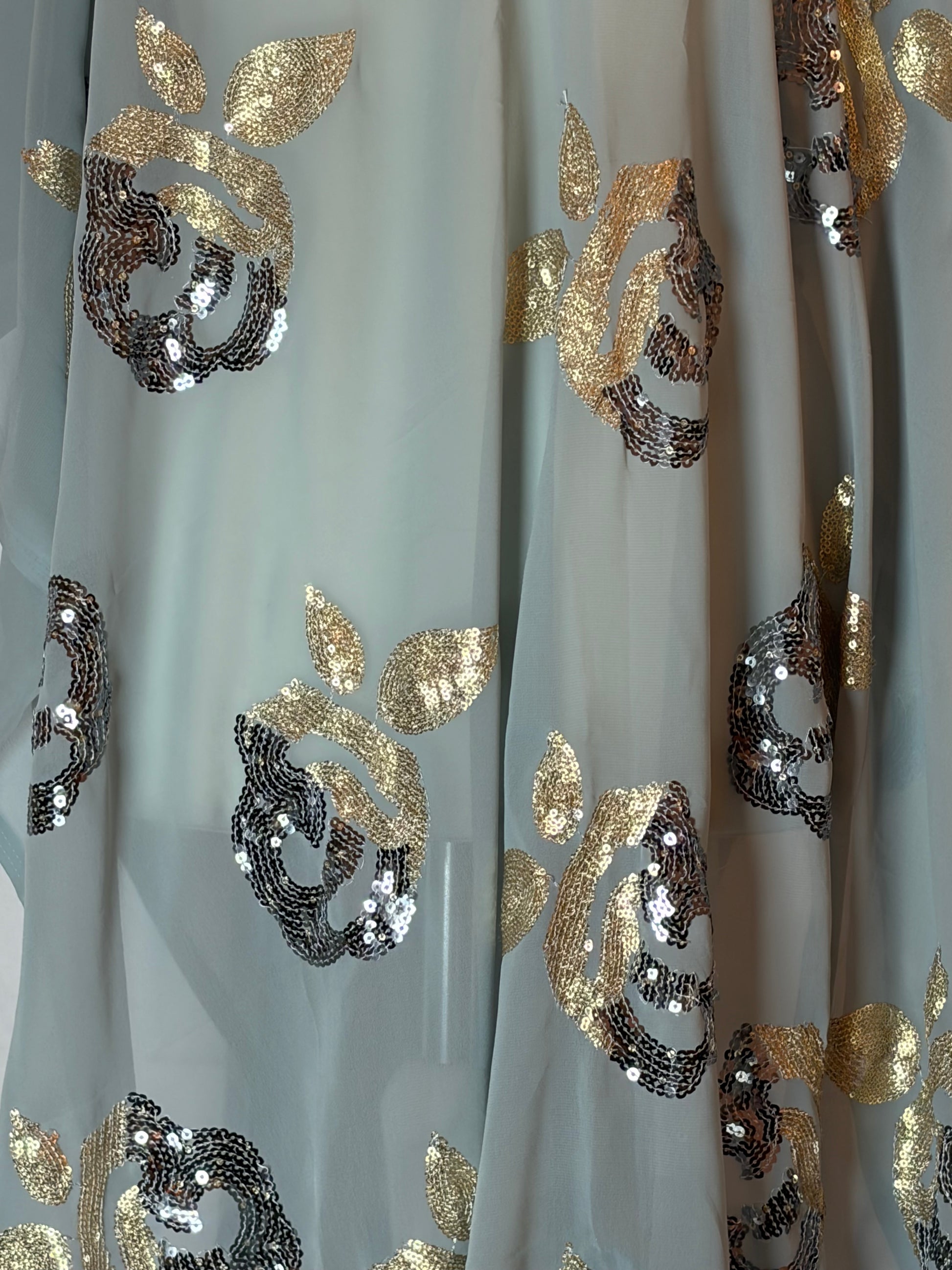 somali Garbasaar fabric with gold and silver floral patterns on a white background
