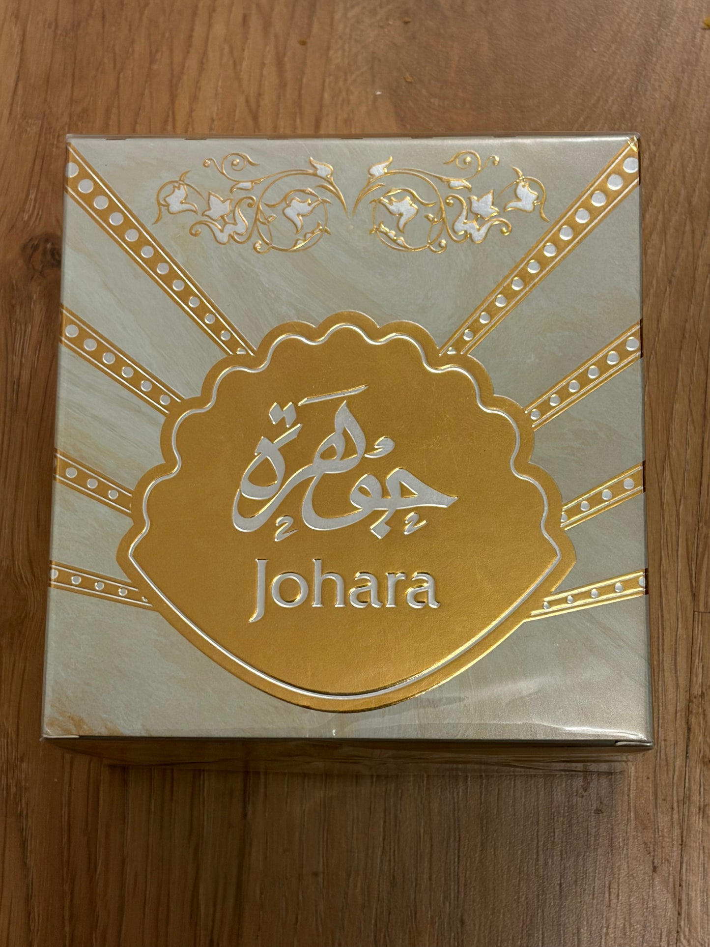 Johara product packaging on a wooden surface
