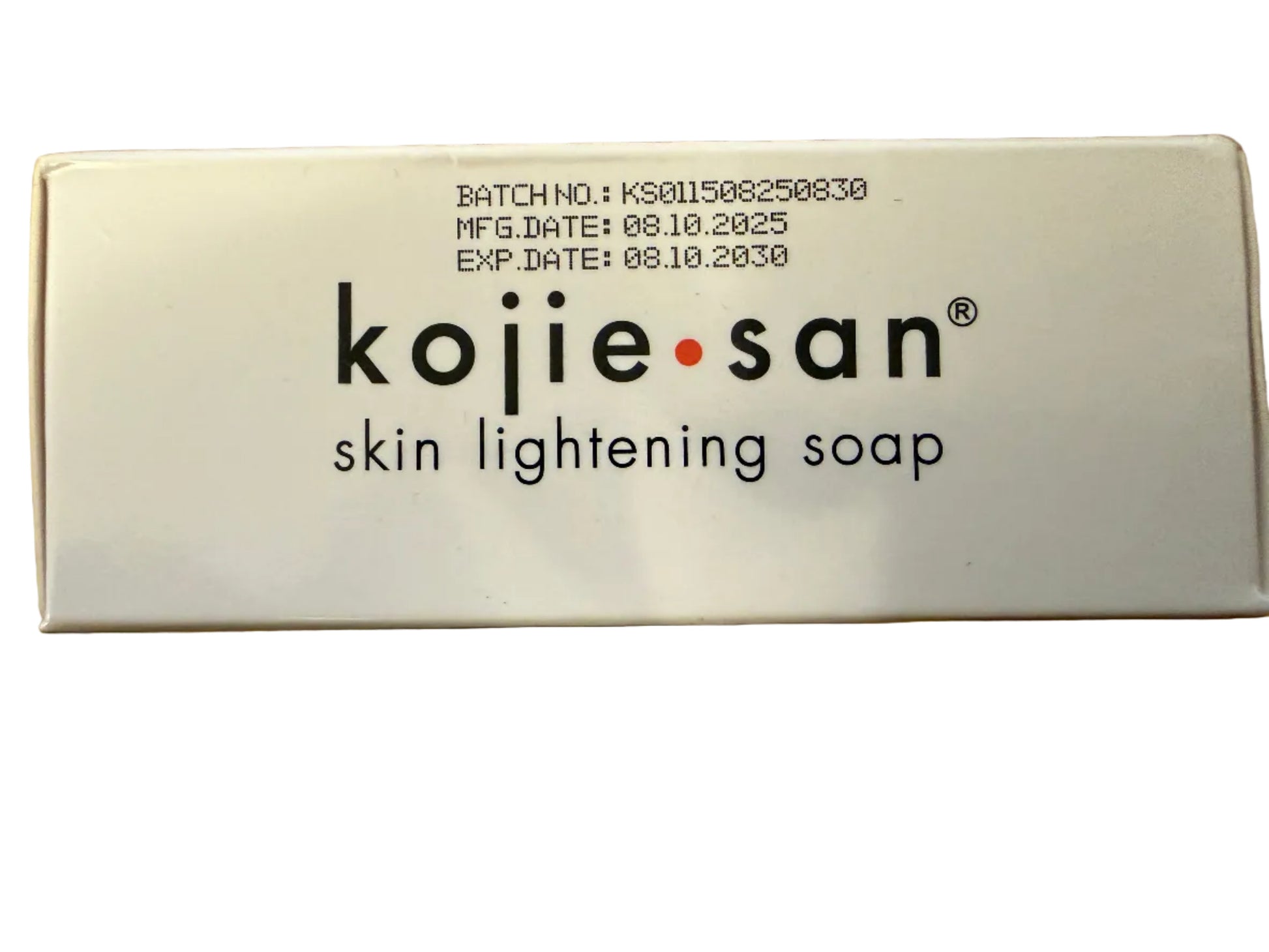 Kojie San skin lightening soap packaging on a cardboard background