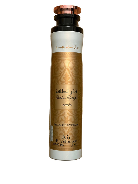 A tall cylindrical air freshener bottle labeled 'Laktaria' with a metallic gold patterned body, white top and bottom bands, and a rose-gold cap, shown on a plain white background.
