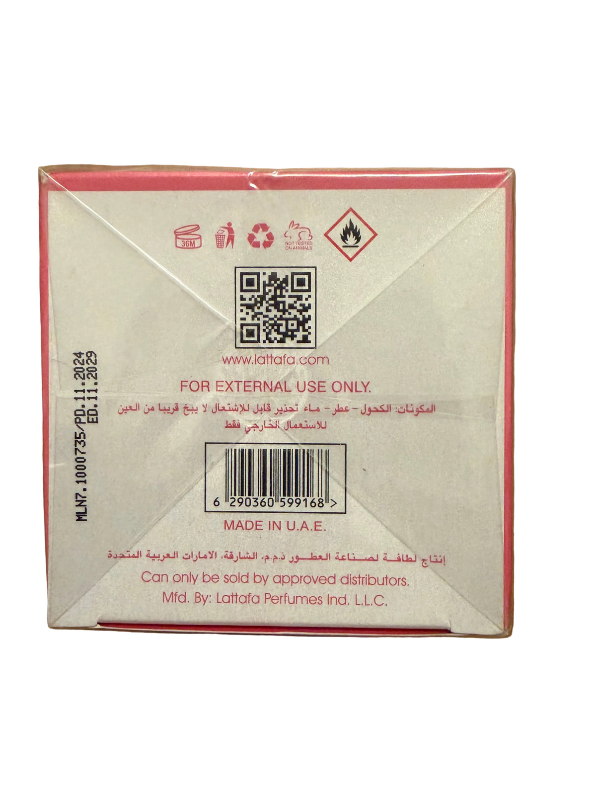 The back of a Lattafa perfume box on a wooden surface, showing a QR code, barcode, and text indicating external use only and Made in U.A.