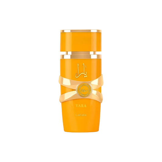 A tall cylindrical orange bottle with gold metallic accents and a gold ribbon around the middle, shown on a plain light gray background. The bottle has Arabic script, the word 'YARA', and a small circular gold seal.