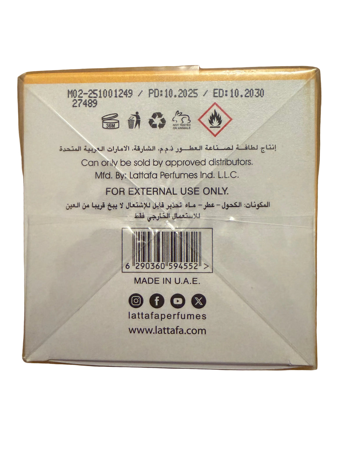 The back of a Lattafa perfume box on a wooden surface, showing product code M02-251001249, barcode, distributor text, and Lattafa branding.