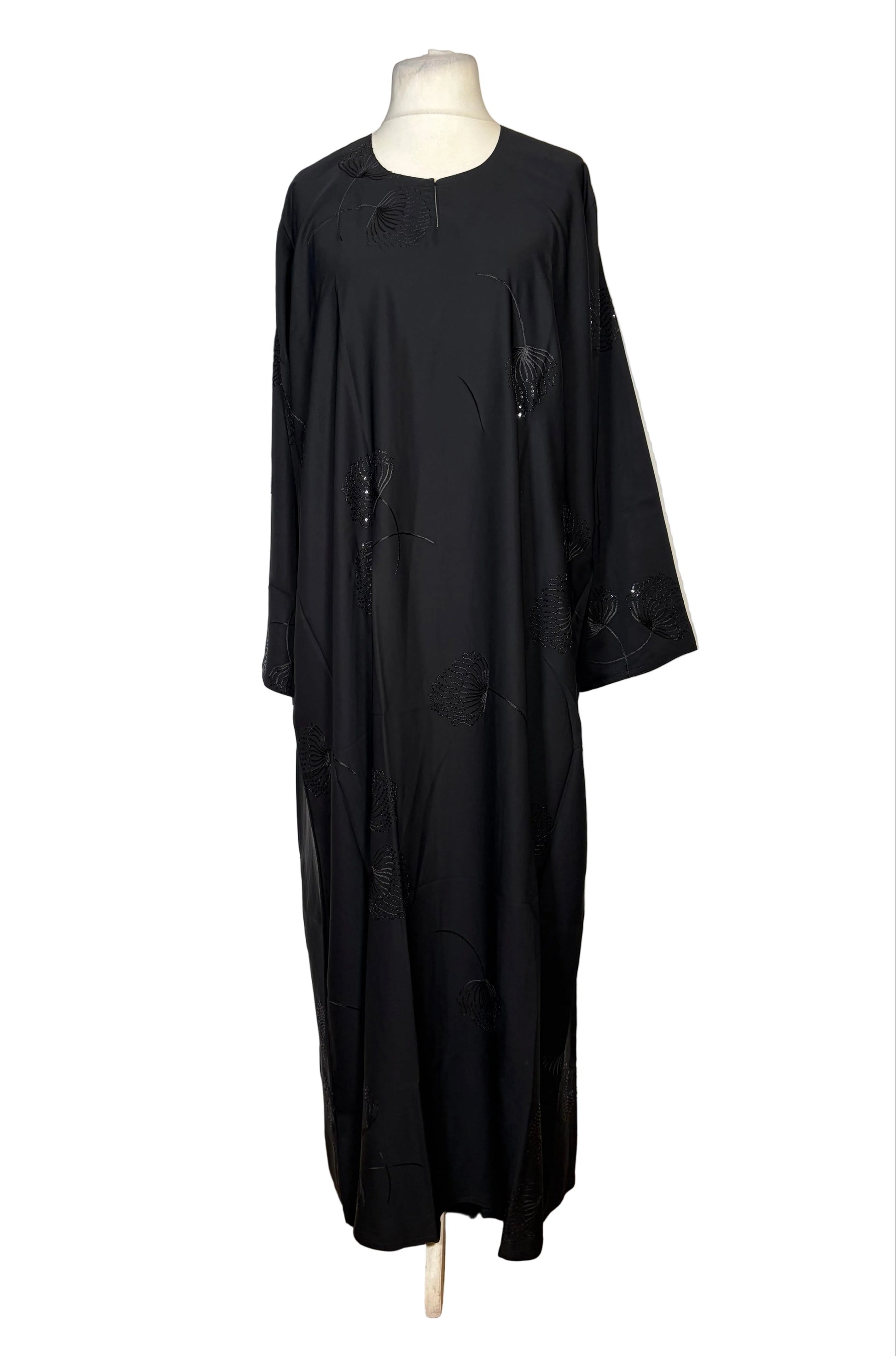 Black Abaya on a mannequin against a white background