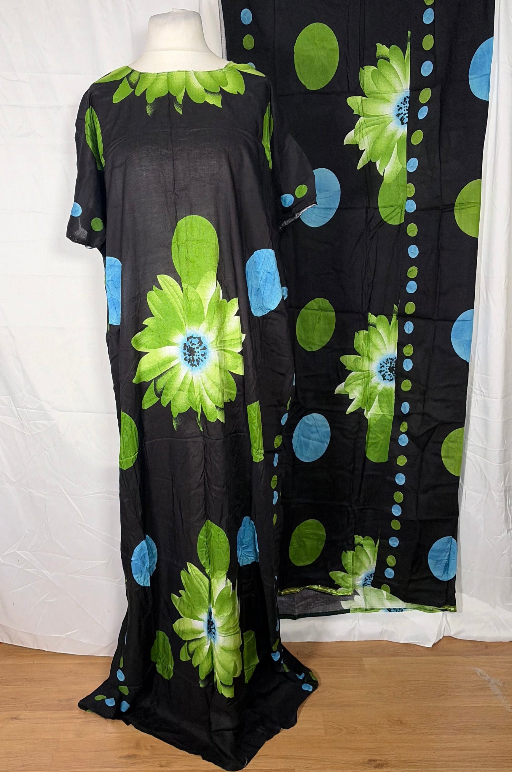 Floral-patterned fabric on a white surface with a wooden floor in the background