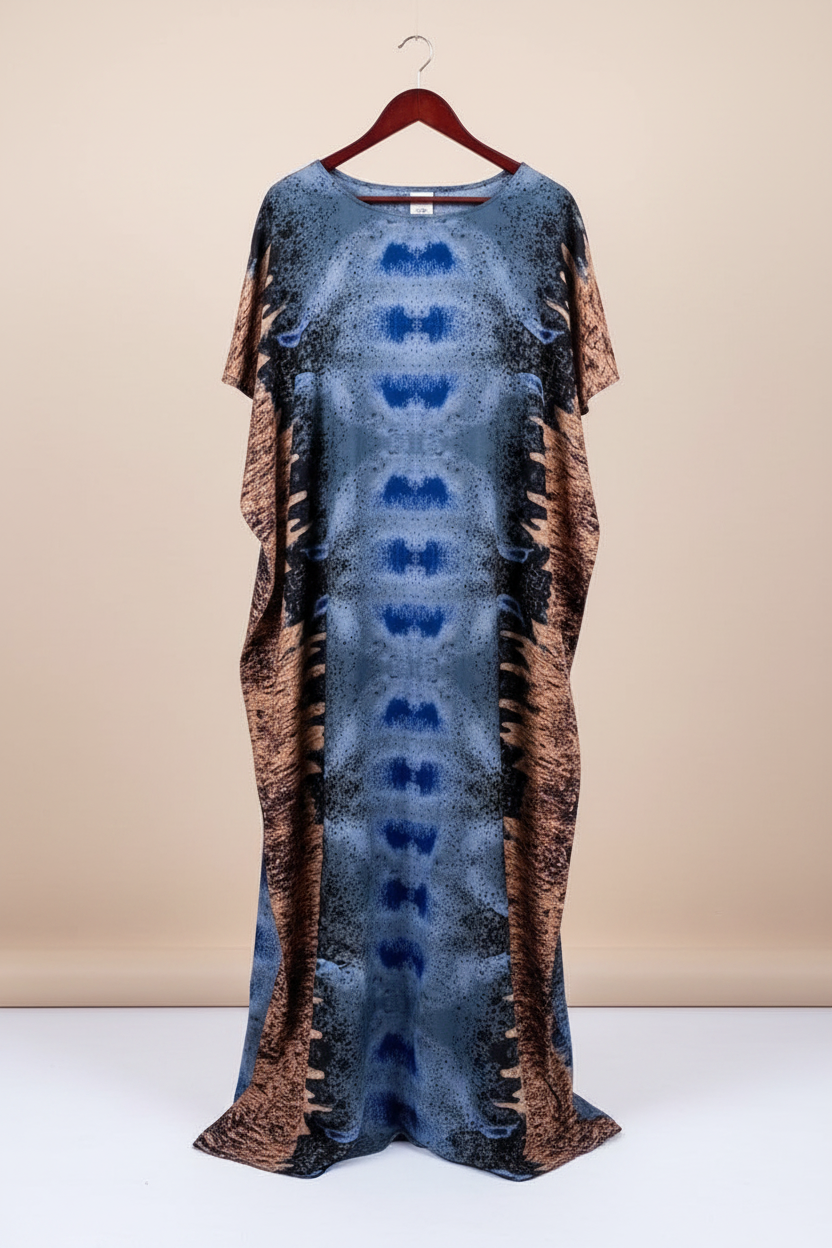 Long dress with blue and brown pattern on a hanger against a beige background
