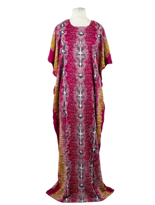 Long, patterned dress on a mannequin against a white background