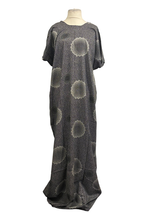 Long gray dress with circular patterns on a mannequin against a white backdrop
