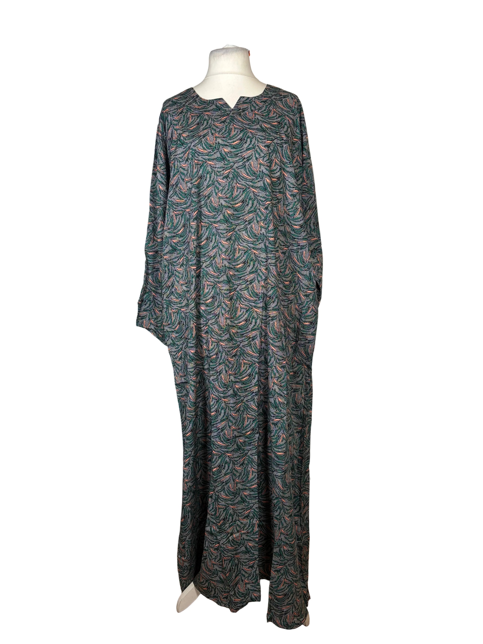 Long patterned dress on a mannequin against a white backdrop