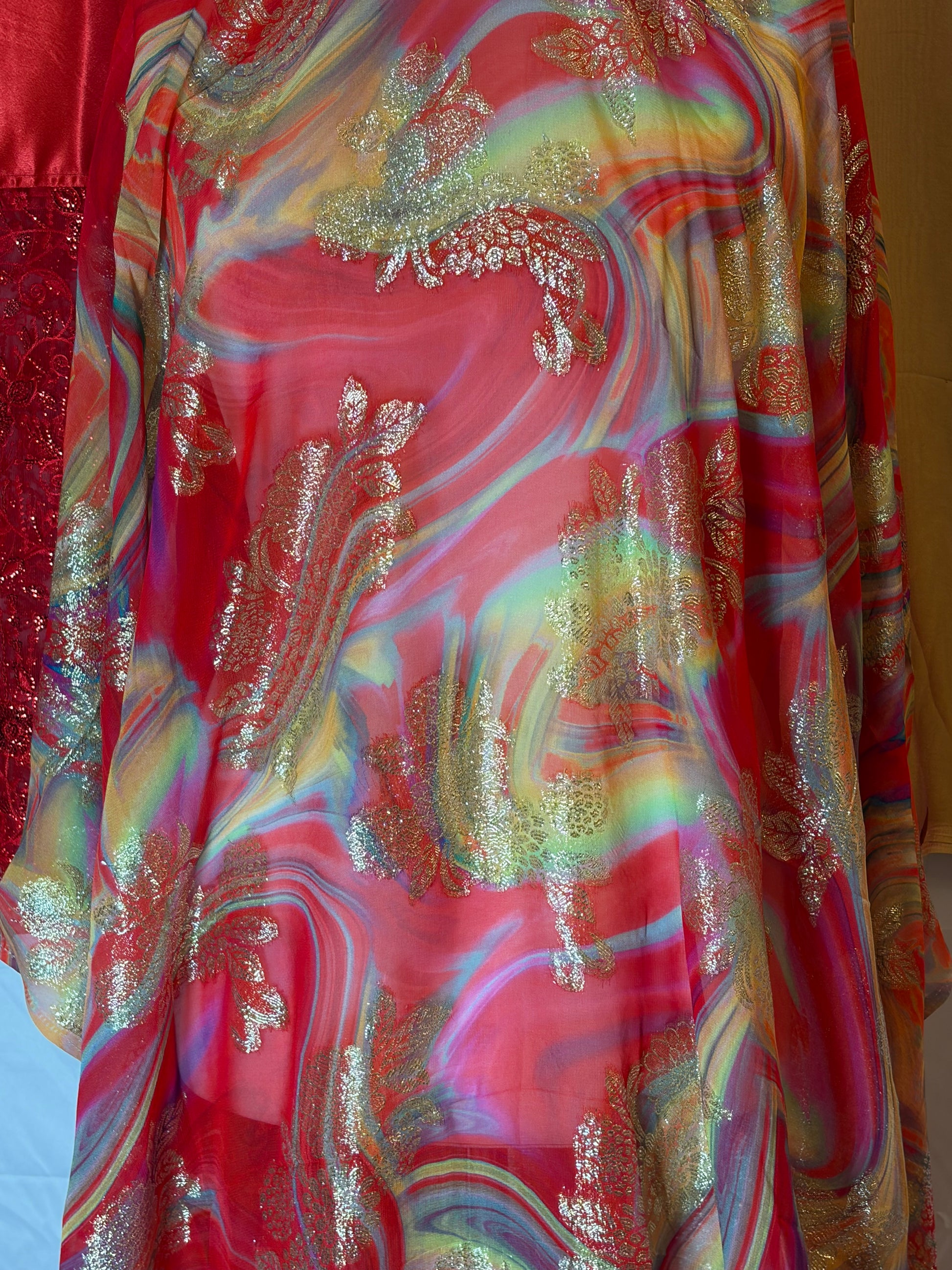 Colorful fabric with a marbled pattern and metallic accents.