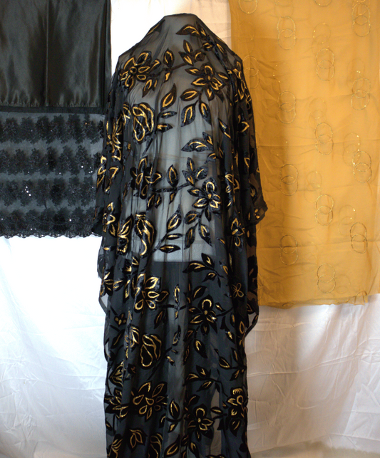 Black Fabric with gold floral embroidery on a white background