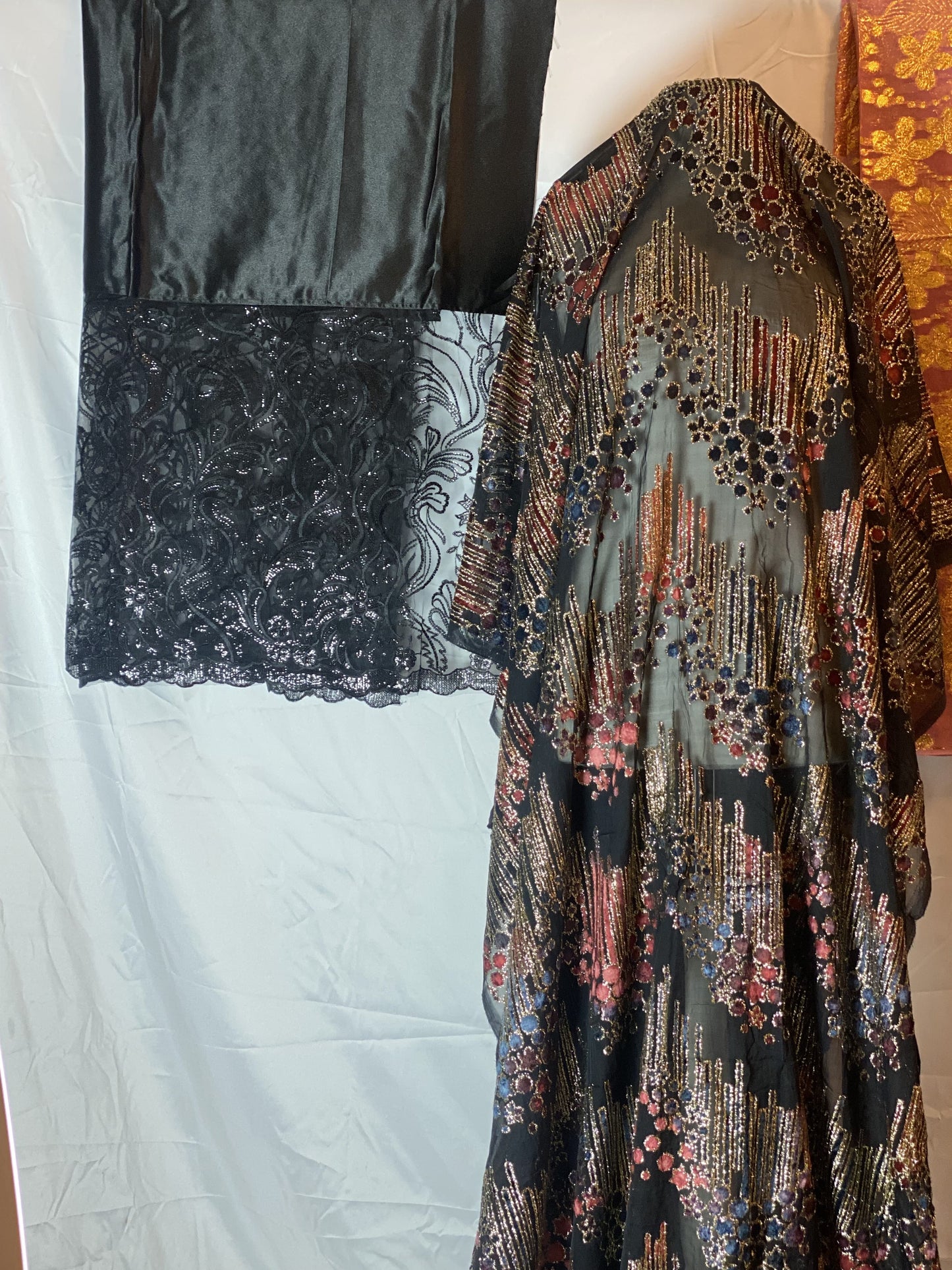 Patterned Somali Dirac garment on a white surface with a colorful background