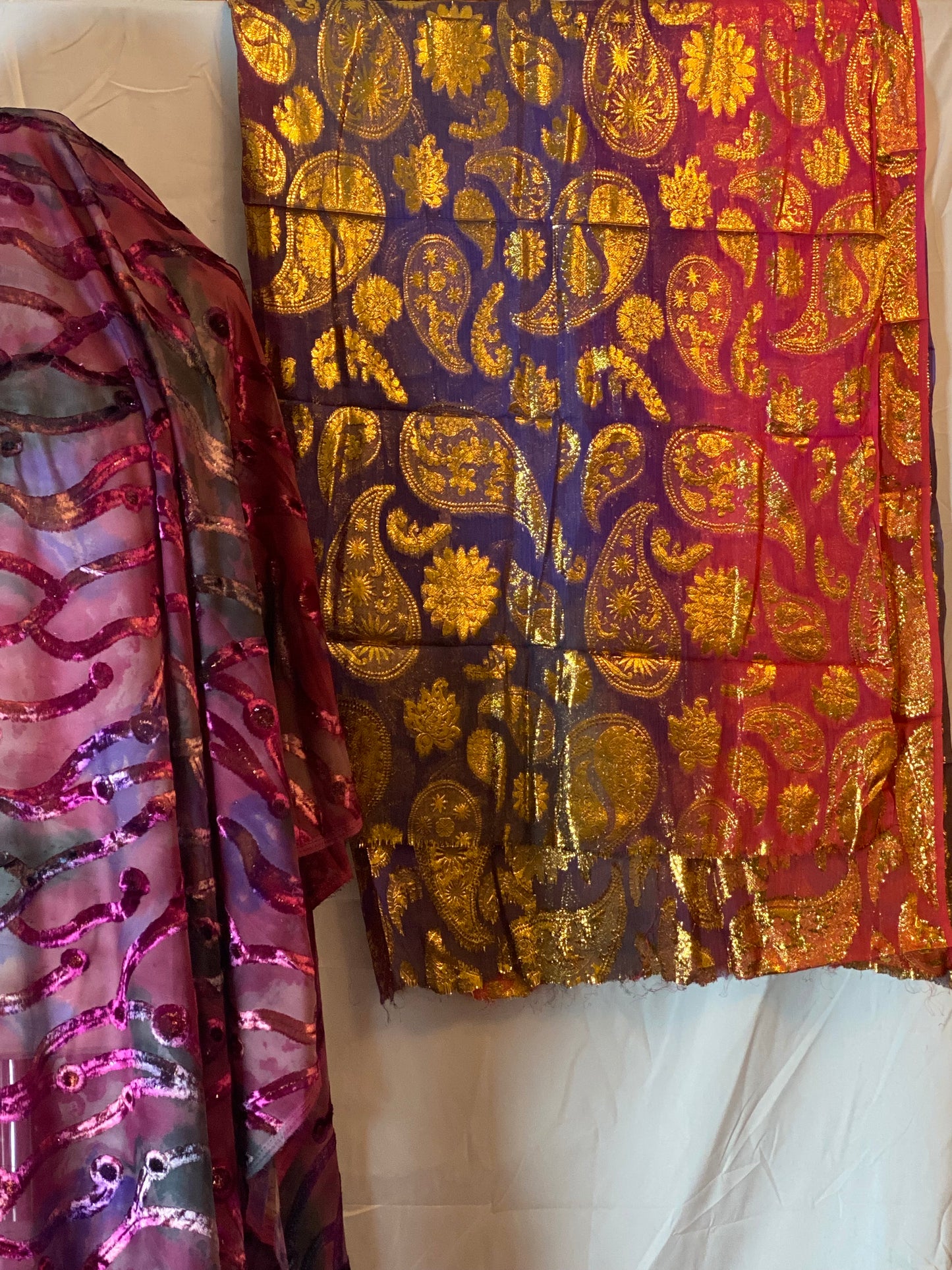 Two pieces of Dirac gabasaar fabric with intricate patterns on a white surface