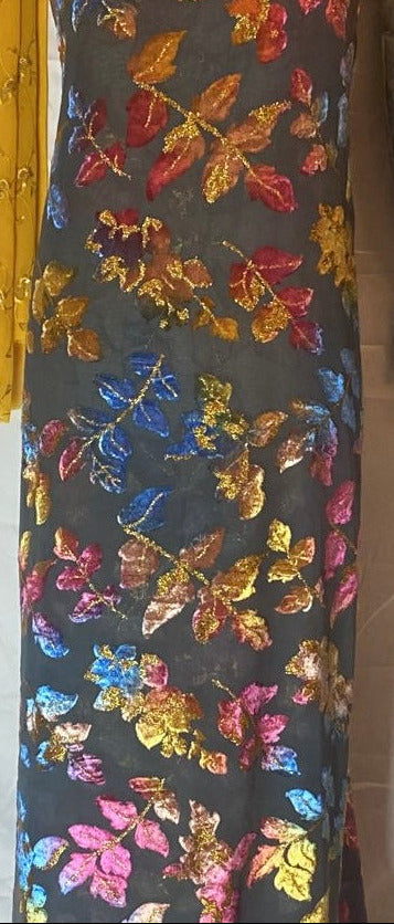 Colorful floral patterned Maqbal Somali Dirac fabric on a dark background