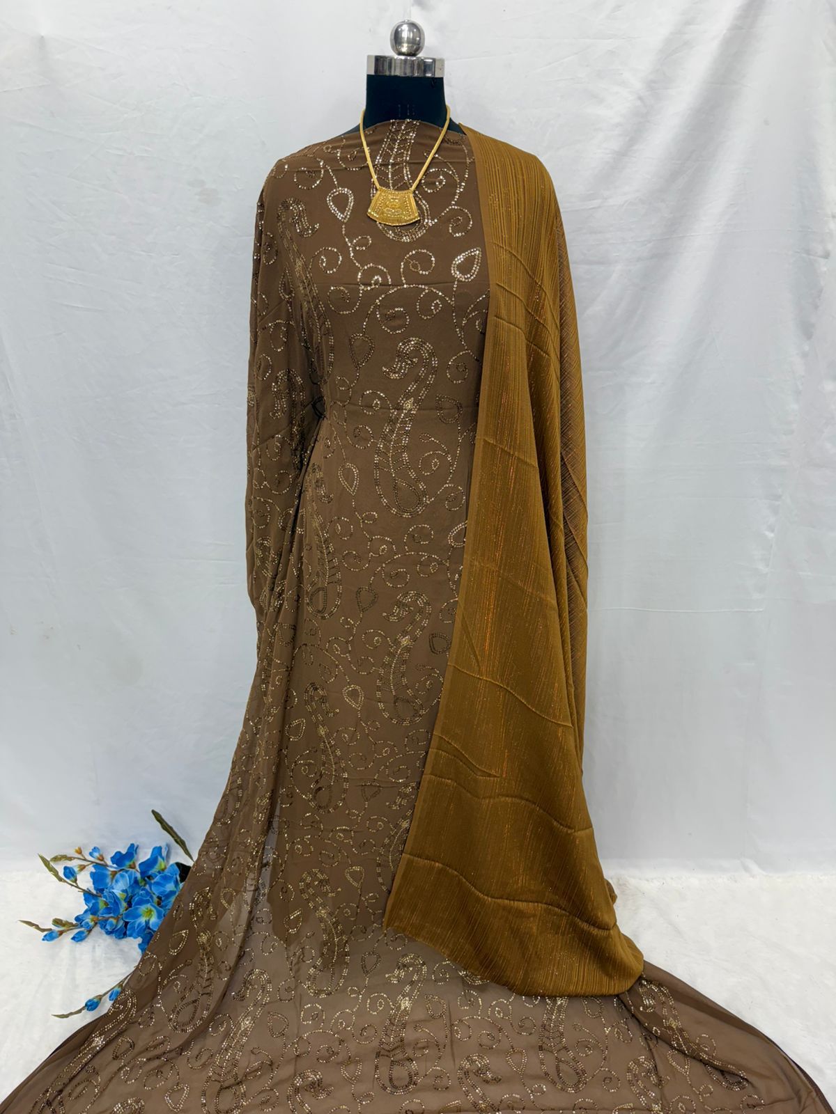 Brown embroidered Maysa Dirac Fabric on a mannequin with a white background