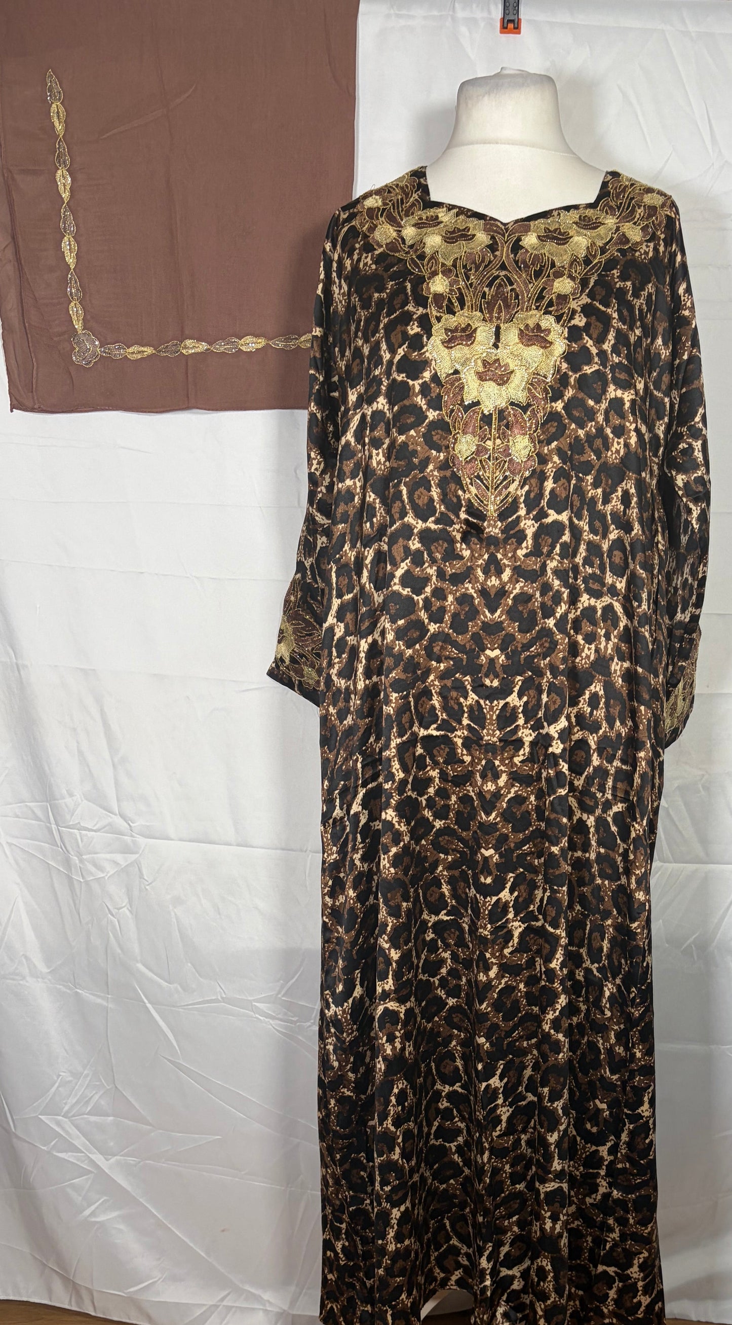 Leopard print Mukawarar dress on a mannequin against a white backdrop