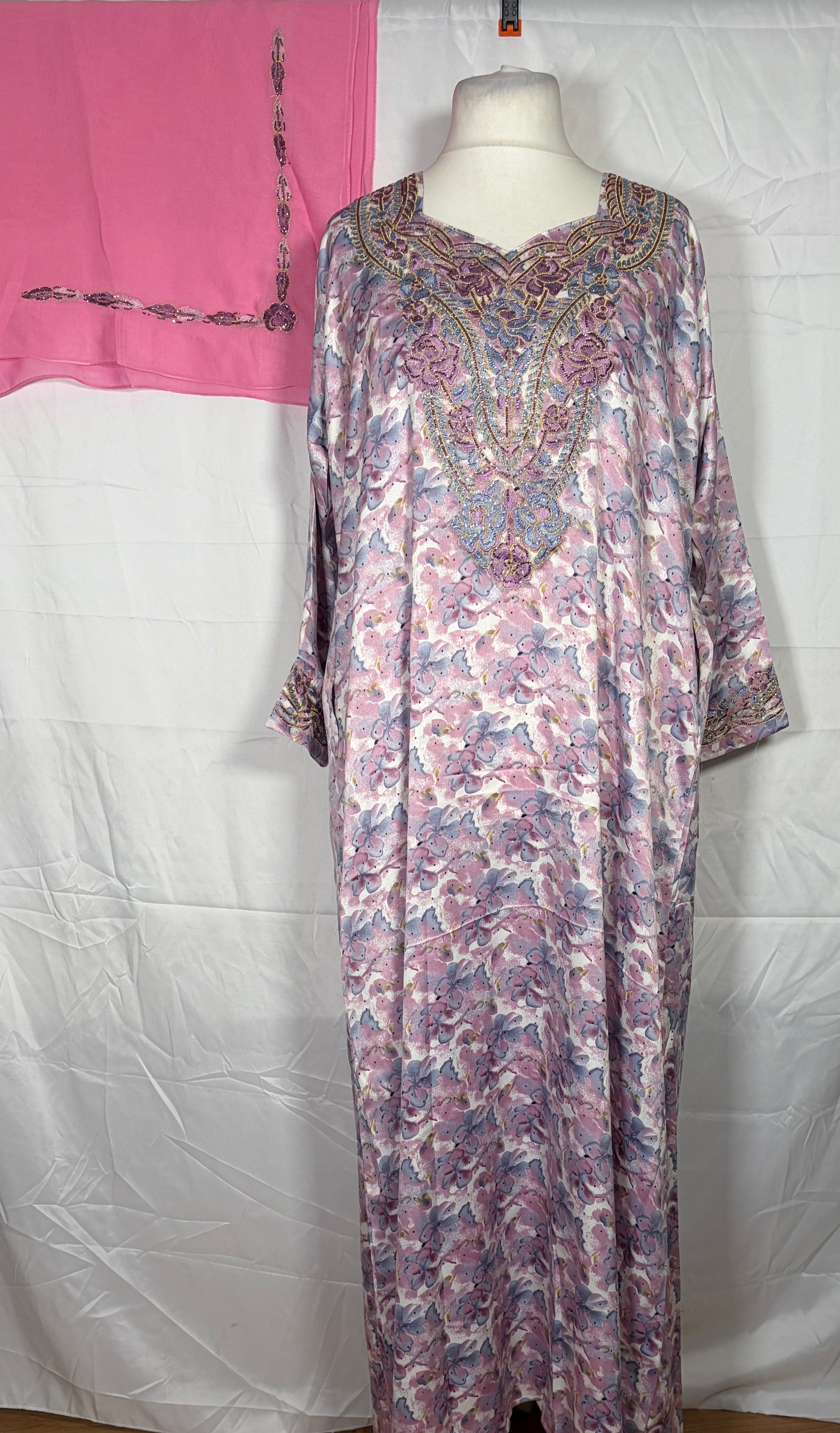 Floral patterned Mukawarar dress on a mannequin against a white background