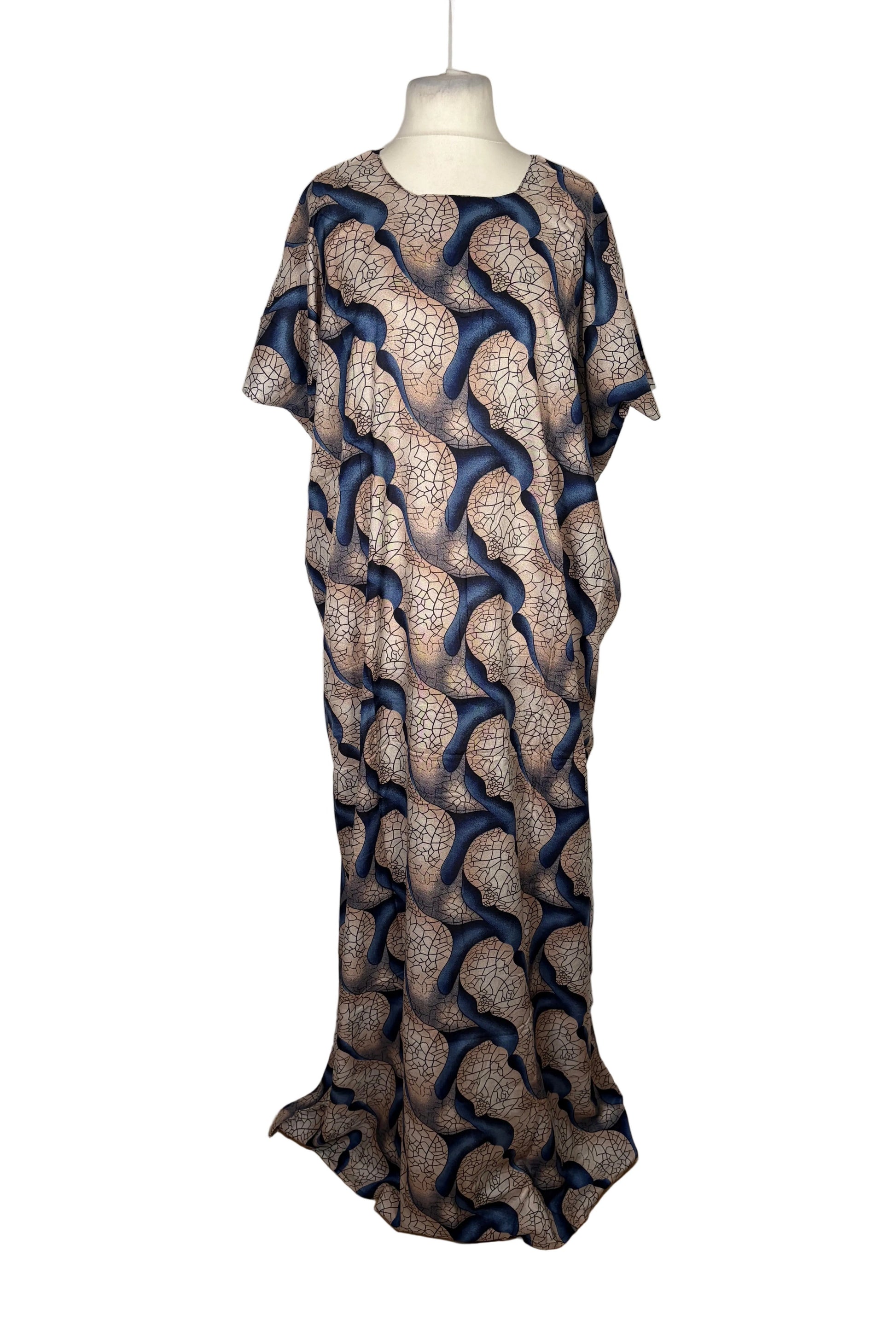 Long Somali Baati dress with a pattern on a mannequin against a white curtain background