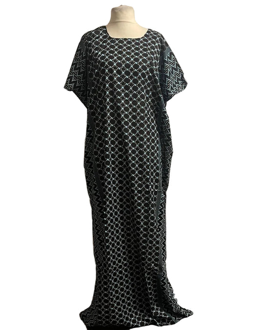 Black and white patterned Somali baati dress on a mannequin against a white background