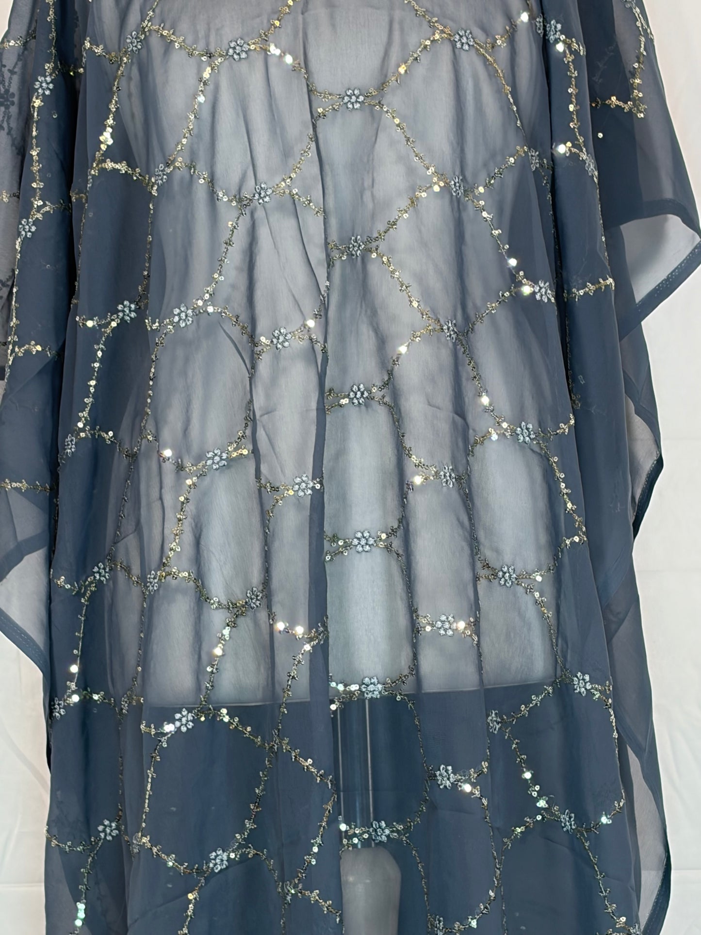 Navy blue fabric with silver sequin patterns on a white background