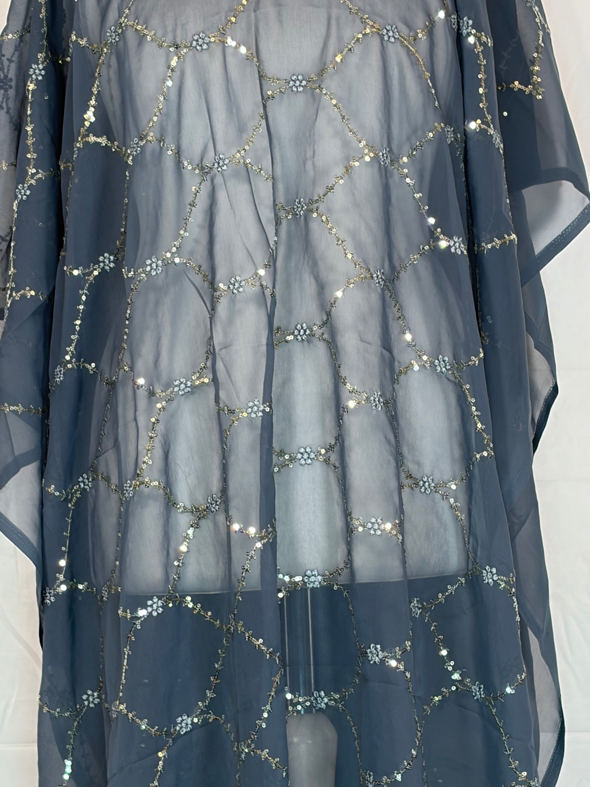 Navy blue fabric with silver sequin patterns on a white background