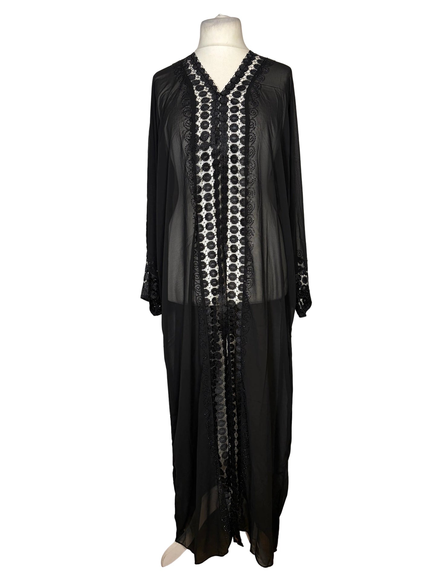 Black dress with white pattern on a mannequin against a white background