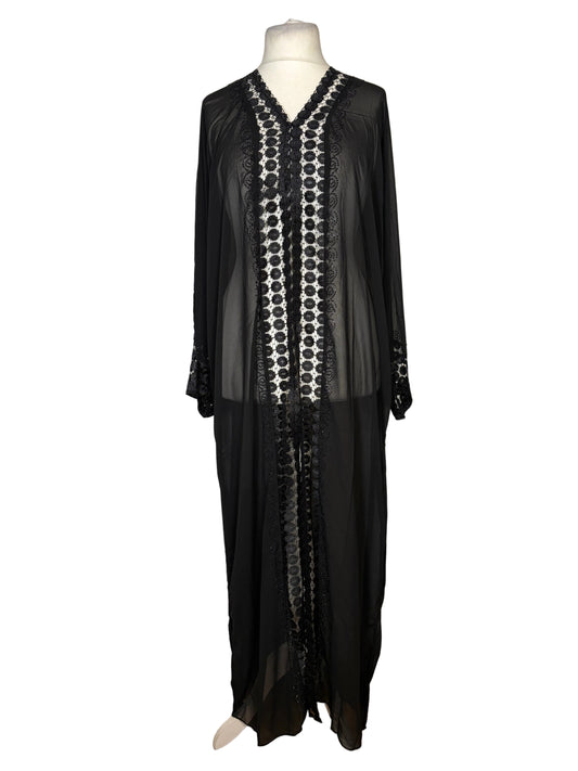 Black dress with white pattern on a mannequin against a white background