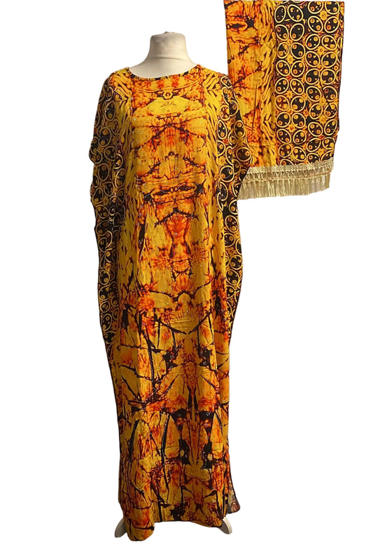 Yellow and black patterned Somali baati on a mannequin against a white background