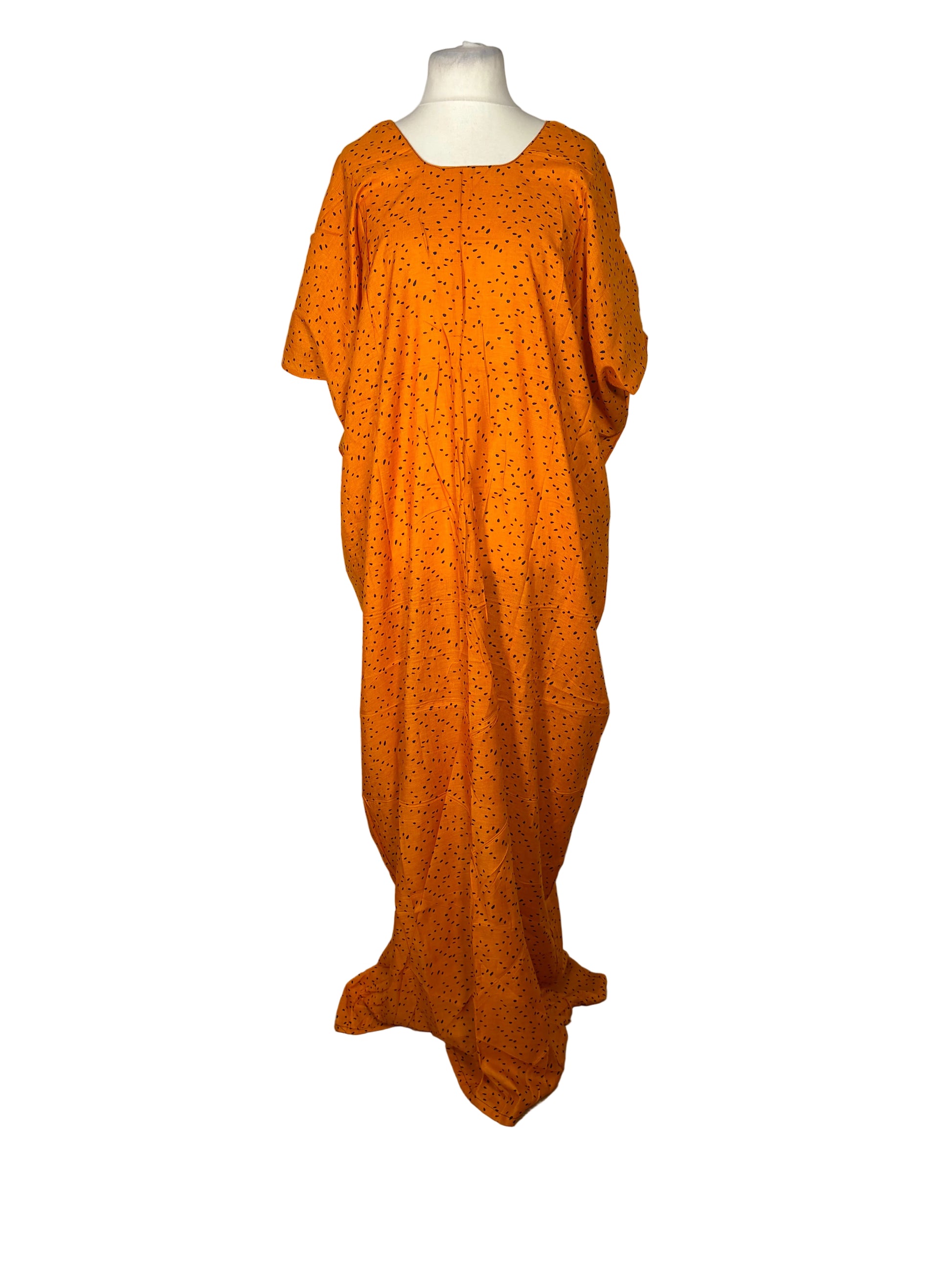 Orange dress on a mannequin against a white backdrop