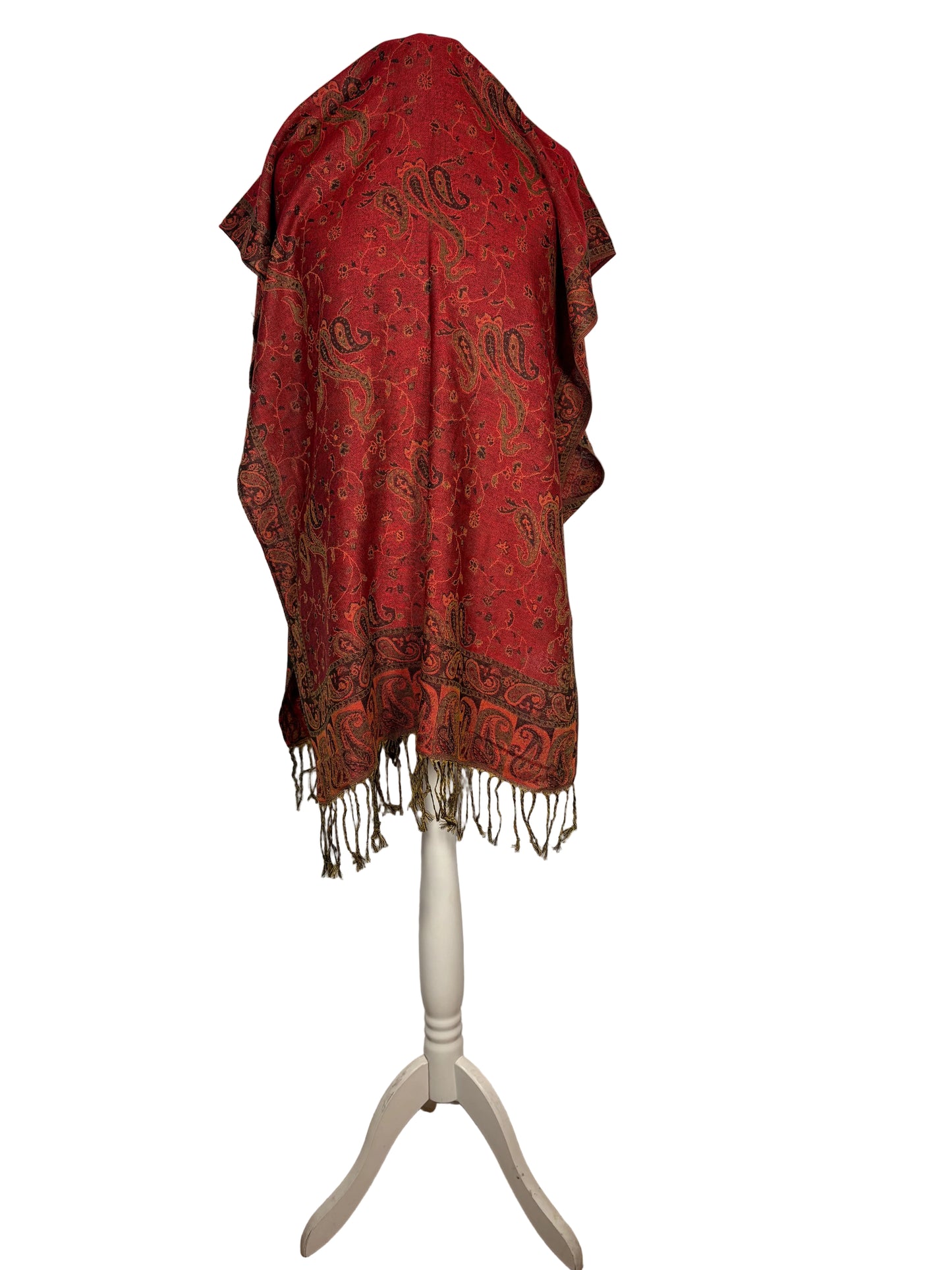 Red patterned scarf on a white stand against a white background