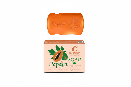 Orange bar of soap with 'Papaya' branding and its packaging on a white background