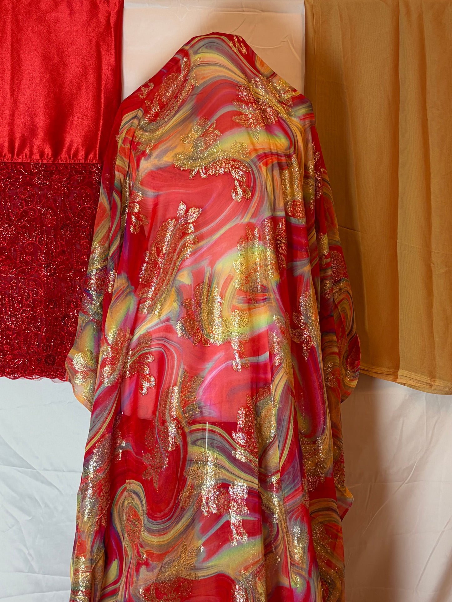 Pink fransawi Dirac fabric with gold patterns on a white surface
