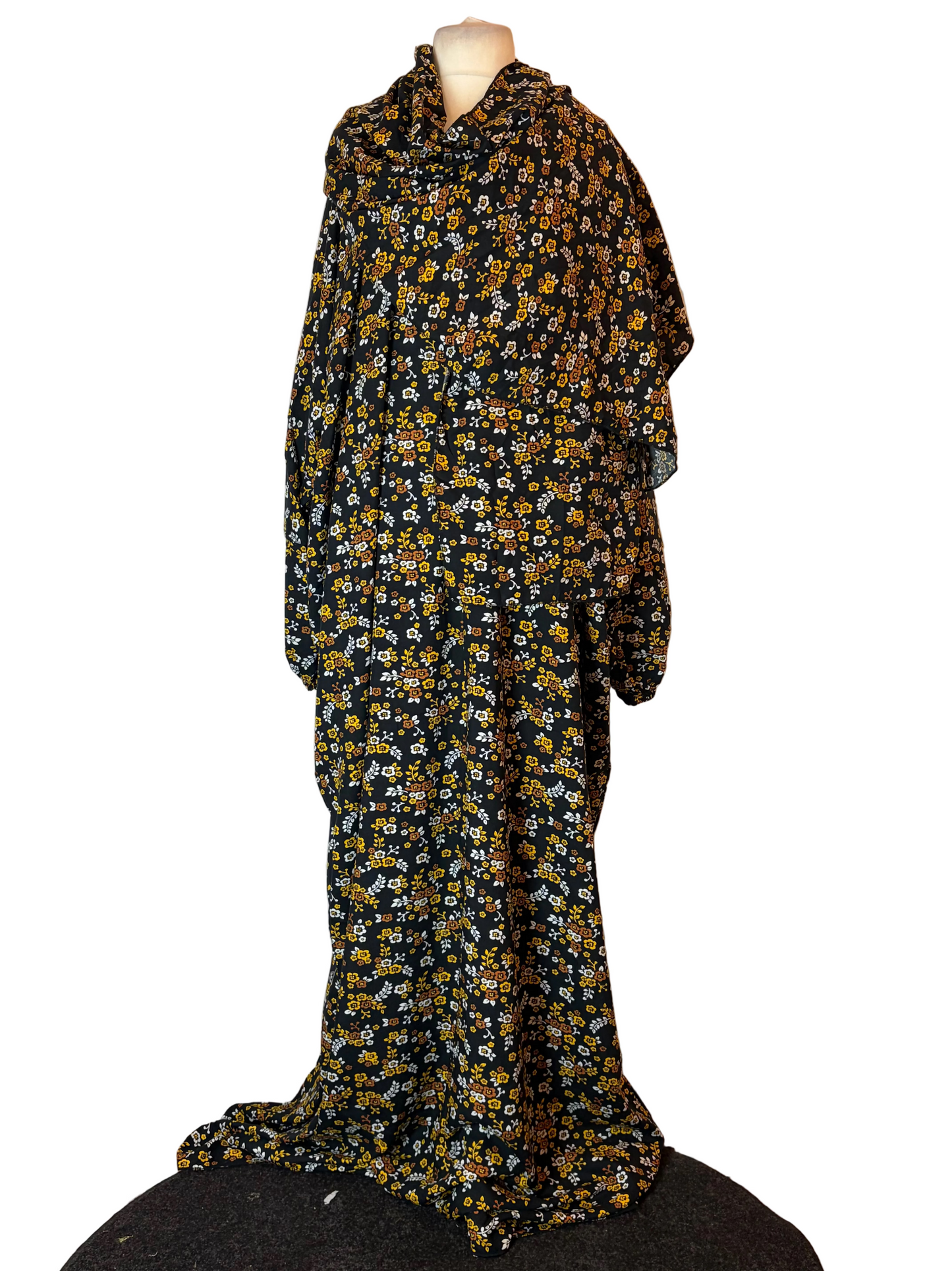 Floral patterned dress on a mannequin against a plain background