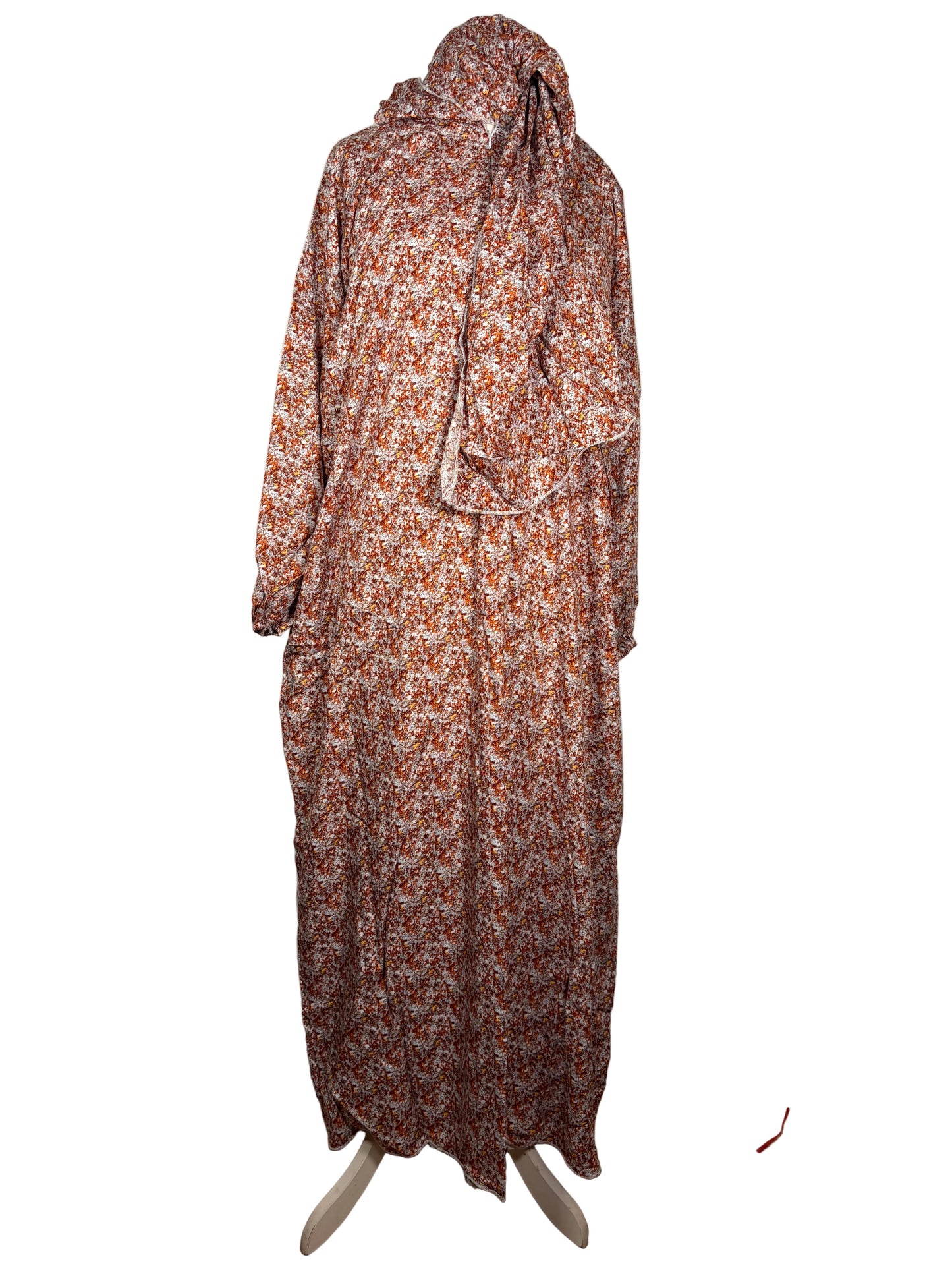 Floral dress on a mannequin against a white backdrop