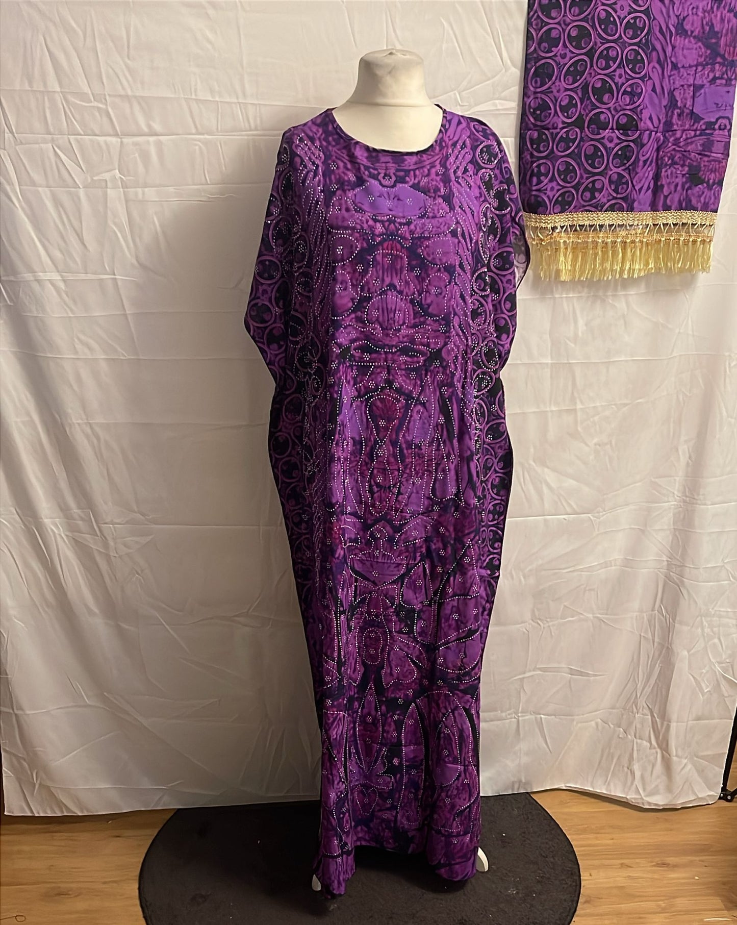 Purple patterned Somali Baati on a mannequin against a white backdrop