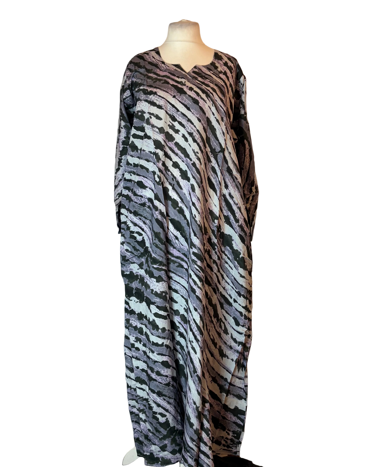 Mannequin wearing a zebra-striped dress against a plain background