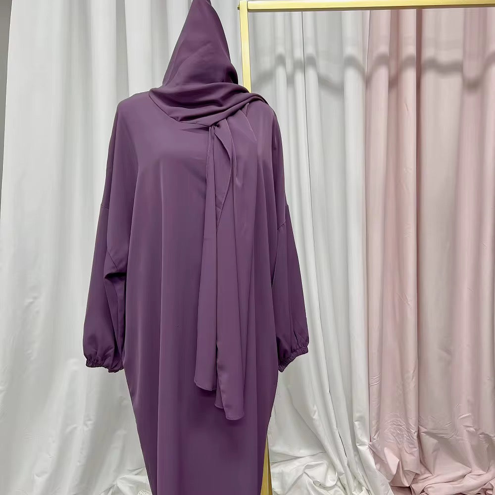 Purple abaya dress hanging on a rack 