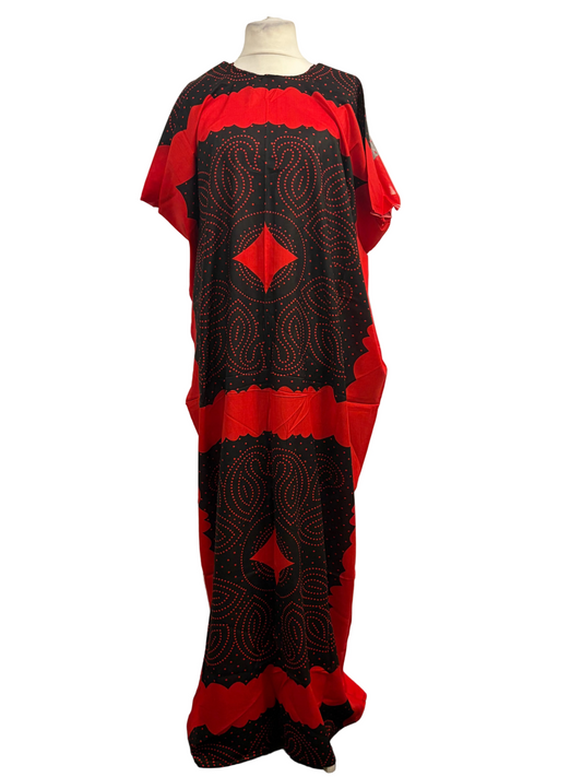 Red and black patterned dress on a mannequin against a white background