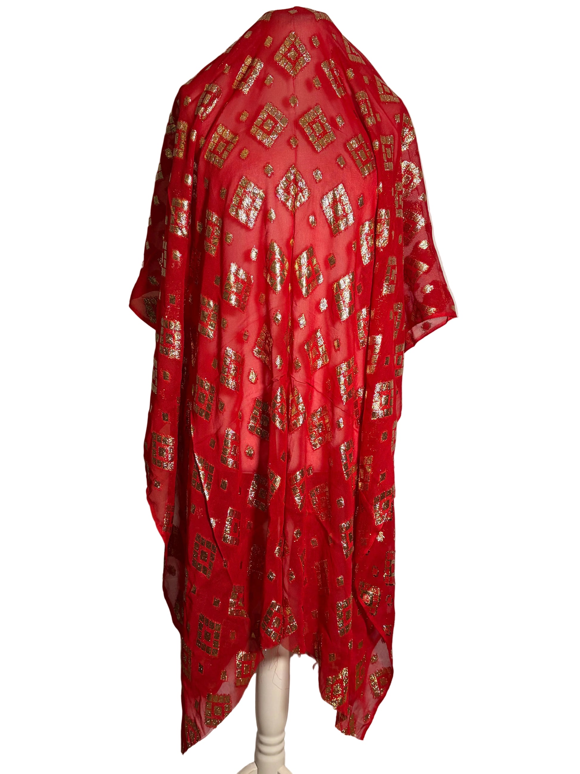 Red patterned Somali garbasaar draped over a mannequin against a white background