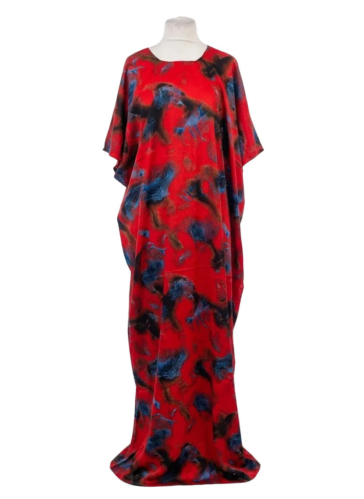 Red and black patterned Somali baati dress on a mannequin against a white background