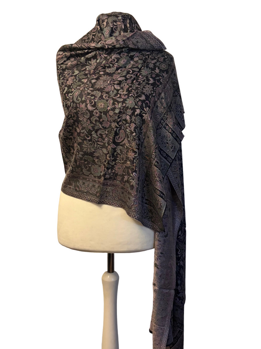 Patterned scarf draped over a mannequin against a plain background